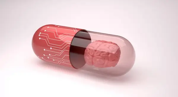 Czerwona kapsułka z obwodem drukowanym zawiera mózg, symbolizując potencjalne leki, np. inhibitory MAO, wpływające na funkcje poznawcze.