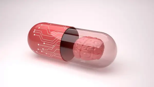 Czerwona kapsułka z obwodem drukowanym zawiera mózg, symbolizując potencjalne leki, np. inhibitory MAO, wpływające na funkcje poznawcze.